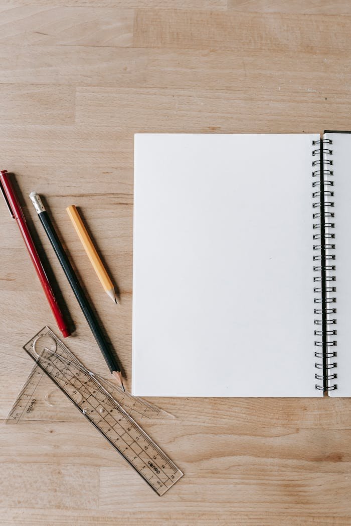 Pencils and rulers near notebook on table